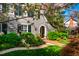 Beautiful home showcasing manicured landscaping and charming architectural details, framed by blooming trees at 205 N Boundary St, Chapel Hill, NC 27514