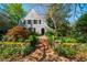 Charming home featuring a unique architectural design with lush landscaping and a welcoming brick walkway at 205 N Boundary St, Chapel Hill, NC 27514