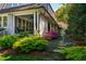Charming home exterior with a covered porch, beautiful landscaping, and stone walkway at 205 N Boundary St, Chapel Hill, NC 27514
