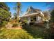 Charming home with a lush green lawn, mature trees, and inviting front porch at 205 N Boundary St, Chapel Hill, NC 27514