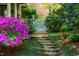 Picturesque garden path with stepping stones and white gate surrounded by colorful flowers at 205 N Boundary St, Chapel Hill, NC 27514