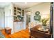 Home office with a built-in bar area, a desk, and hardwood floors at 205 N Boundary St, Chapel Hill, NC 27514