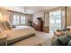 Bright main bedroom boasts hardwood floors, a ceiling fan, and luxurious furnishings at 205 N Boundary St, Chapel Hill, NC 27514