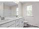 Bathroom featuring dual vanity sinks, white cabinetry, a large mirror, and a nearby toilet at 317 Highland Ridge Ln, Knightdale, NC 27545