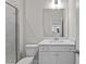 Bright bathroom features a white vanity, marble-look tiling and a glass enclosed shower at 317 Highland Ridge Ln, Knightdale, NC 27545