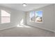This carpeted room has big windows at 317 Highland Ridge Ln, Knightdale, NC 27545