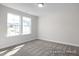 Well-lit bedroom featuring neutral walls and carpet at 317 Highland Ridge Ln, Knightdale, NC 27545