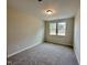 Bedroom features neutral carpet and paint and two windows at 317 Highland Ridge Ln, Knightdale, NC 27545