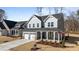 Attractive two-story home with gray siding, a lovely front porch, and a convenient two-car garage at 317 Highland Ridge Ln, Knightdale, NC 27545