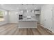 Open kitchen with a large island, stainless steel appliances, and sleek countertops at 317 Highland Ridge Ln, Knightdale, NC 27545