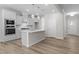 Well-lit kitchen with stainless steel appliances, a center island, and modern finishes at 317 Highland Ridge Ln, Knightdale, NC 27545