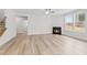 Bright living room features a fireplace, wood flooring, and abundant natural light at 317 Highland Ridge Ln, Knightdale, NC 27545