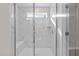 Modern bathroom shower with floor to ceiling marble and glass door at 317 Highland Ridge Ln, Knightdale, NC 27545