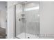 Walk-in shower with marble tile and glass enclosure at 317 Highland Ridge Ln, Knightdale, NC 27545