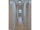 Hallway with wooden floors leading to a bedroom that offers natural light and a calming blue at 352 Faucette Mill Rd, Hillsborough, NC 27278