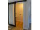 The laundry room boasts a washer and dryer hookup, storage shelves, and a modern barn door at 352 Faucette Mill Rd, Hillsborough, NC 27278