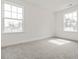Bright and airy bedroom with two large windows and neutral carpeting at 53 Lavender Ln, Clayton, NC 27520