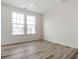 Bright, vacant bedroom featuring hardwood floors and large windows at 53 Lavender Ln, Clayton, NC 27520