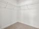 Walk-in closet featuring wire shelving and neutral carpeting at 53 Lavender Ln, Clayton, NC 27520