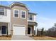 Inviting townhome with stone accents, a one-car garage, and a classic exterior color scheme at 53 Lavender Ln, Clayton, NC 27520