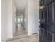 Bright foyer with wood-look flooring, white walls, and a view of the staircase at 53 Lavender Ln, Clayton, NC 27520