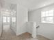 Second-floor hallway with carpet, white walls, a window and linen closet access at 53 Lavender Ln, Clayton, NC 27520