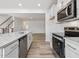 Modern kitchen with stainless steel appliances, white cabinetry, and tile backsplash at 53 Lavender Ln, Clayton, NC 27520