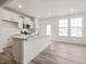Bright kitchen featuring white cabinets, stainless appliances, and an island with a sink at 53 Lavender Ln, Clayton, NC 27520