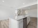Modern kitchen with stainless steel appliances, white cabinetry, and island with sink at 53 Lavender Ln, Clayton, NC 27520