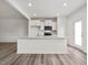 Bright kitchen featuring white cabinets, stainless appliances, and an island with a sink at 53 Lavender Ln, Clayton, NC 27520