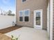 Exterior shot of a concrete patio and the side of a house with siding and windows at 53 Lavender Ln, Clayton, NC 27520