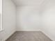 A cozy, carpeted room featuring white walls and ample natural light at 53 Lavender Ln, Clayton, NC 27520