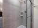 The walk-in shower features gray tiling, a glass door, and built-in shelving at 53 Lavender Ln, Clayton, NC 27520