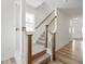 Carpeted staircase with wooden railings and white banisters leading to the second floor at 53 Lavender Ln, Clayton, NC 27520