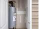 Enclosed utility closet with a water heater and neutral walls next to a door at 53 Lavender Ln, Clayton, NC 27520