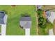 A bird's eye view of the home with a grey roof and surrounding green yard at 60 Bennett Rd, Coats, NC 27521