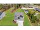 Aerial view of a two-story home with a sprawling backyard and a manicured lawn surrounded by mature trees at 60 Bennett Rd, Coats, NC 27521
