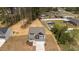 An aerial view of a beautiful two-story home with a large backyard and wooded surroundings at 60 Bennett Rd, Coats, NC 27521