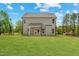 A sprawling backyard featuring a well-manicured lawn with a view of the home's exterior at 60 Bennett Rd, Coats, NC 27521