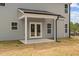 Covered porch with double doors leading to the backyard at 60 Bennett Rd, Coats, NC 27521