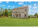 A shot of the backyard and house, showing the well-maintained lawn and exterior at 60 Bennett Rd, Coats, NC 27521