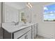 Bathroom with double vanity, large mirror, and natural light from the window at 60 Bennett Rd, Coats, NC 27521