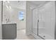 Well-lit bathroom featuring a glass-enclosed shower and vanity at 60 Bennett Rd, Coats, NC 27521