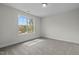 This bedroom features neutral carpet, a light fixture, and a window that provides natural light at 60 Bennett Rd, Coats, NC 27521