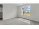 This bedroom features neutral carpet, a light fixture, and a window that provides natural light at 60 Bennett Rd, Coats, NC 27521