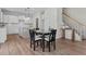 Charming dining area featuring wood floors, a stylish table set, and easy access to kitchen and stairway at 60 Bennett Rd, Coats, NC 27521