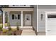 Close up of front entrance featuring a covered porch with white columns and fresh landscaping at 60 Bennett Rd, Coats, NC 27521