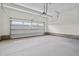 Spacious garage with concrete flooring and overhead door, ready for parking and storage at 60 Bennett Rd, Coats, NC 27521