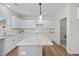 Modern kitchen with sleek white cabinets, granite countertops, stainless steel appliances, and a functional layout at 60 Bennett Rd, Coats, NC 27521