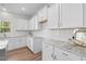 Modern kitchen with white cabinets, granite countertops, and stainless steel appliances at 60 Bennett Rd, Coats, NC 27521